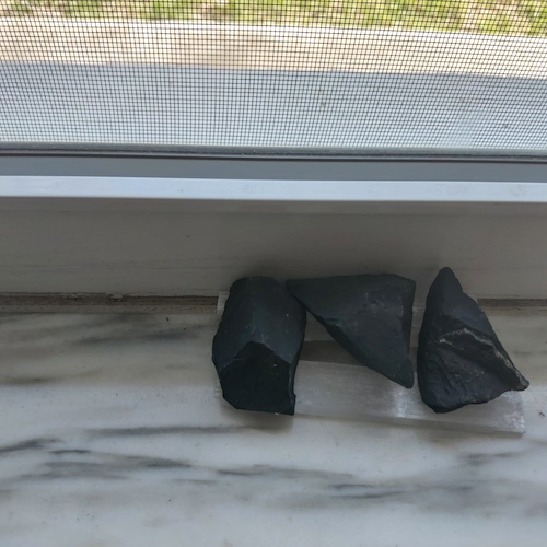 Shungite stones of top of selenite sticks.