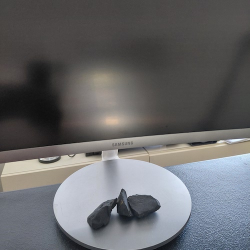 Sungite stones on computer monitor.